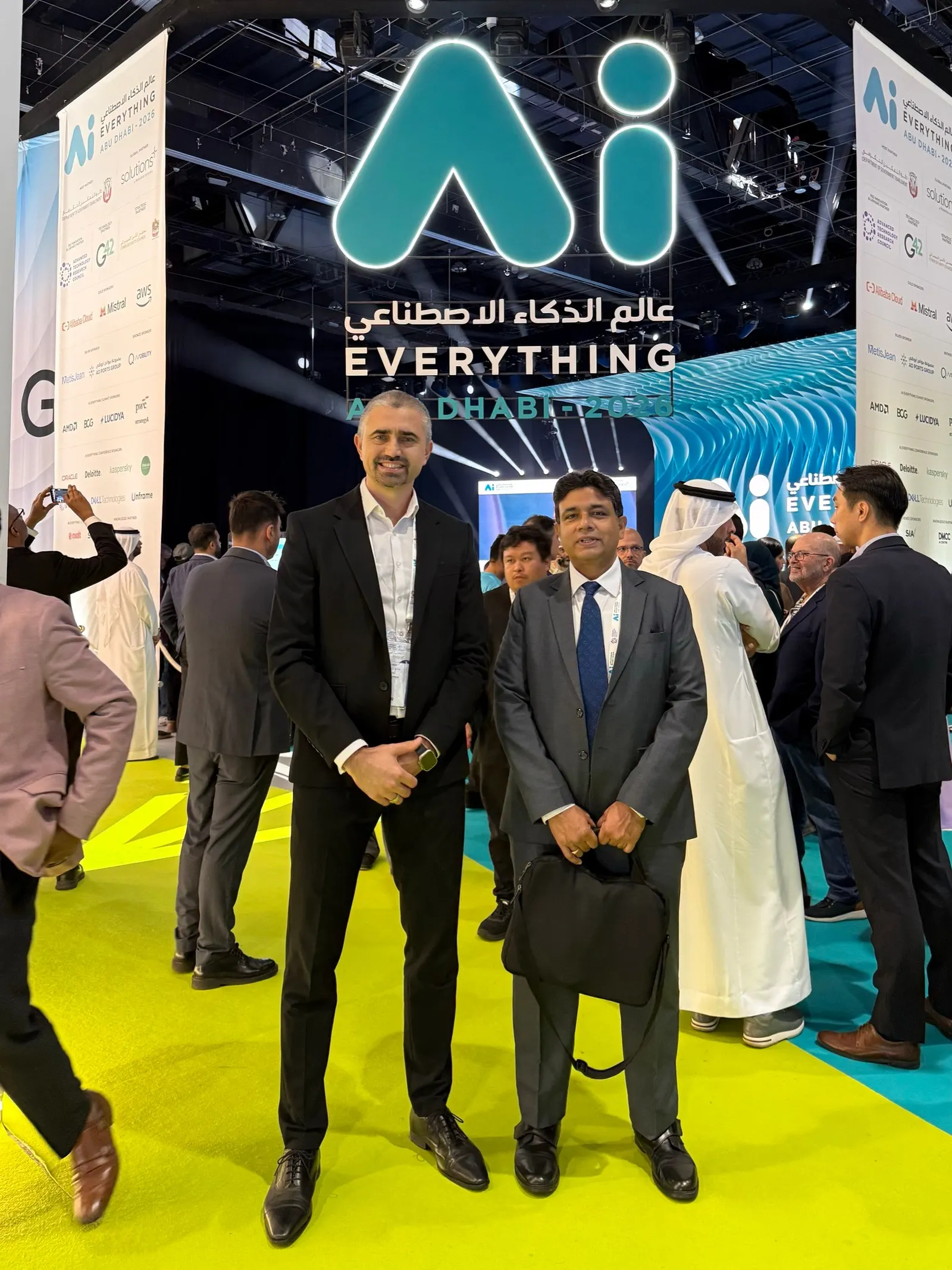 Virgil Dobos and Abdul Razack of Virtech under the Ai Everything Abu Dhabi 2026 sign at ADNEC Centre