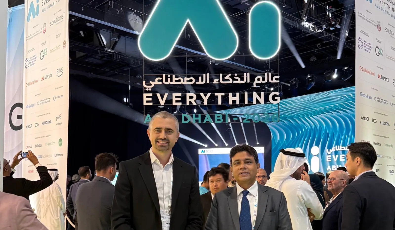 Virgil Dobos and Abdul Razack of Virtech under the Ai Everything Abu Dhabi 2026 sign at ADNEC Centre